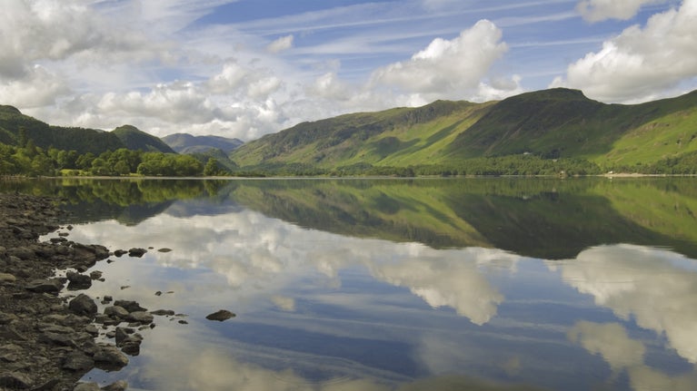 A view over Derwent Water lake looking towards castle crag on a sunny summer's day